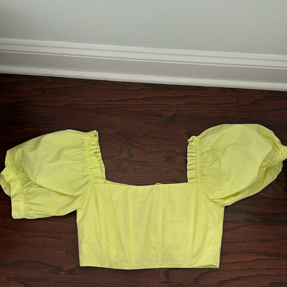 Pale yellow corset crop top.